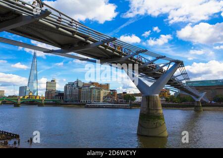 View to Thames River, Millennium Bridge from the north bank-elegant steel suspension footbridge crossing the Thames from the Tate Modern to St Paul`s
